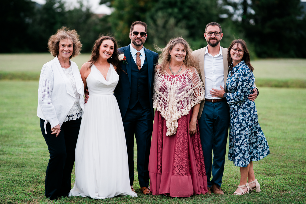 Family and friends gather for a group portrait on the lawn.